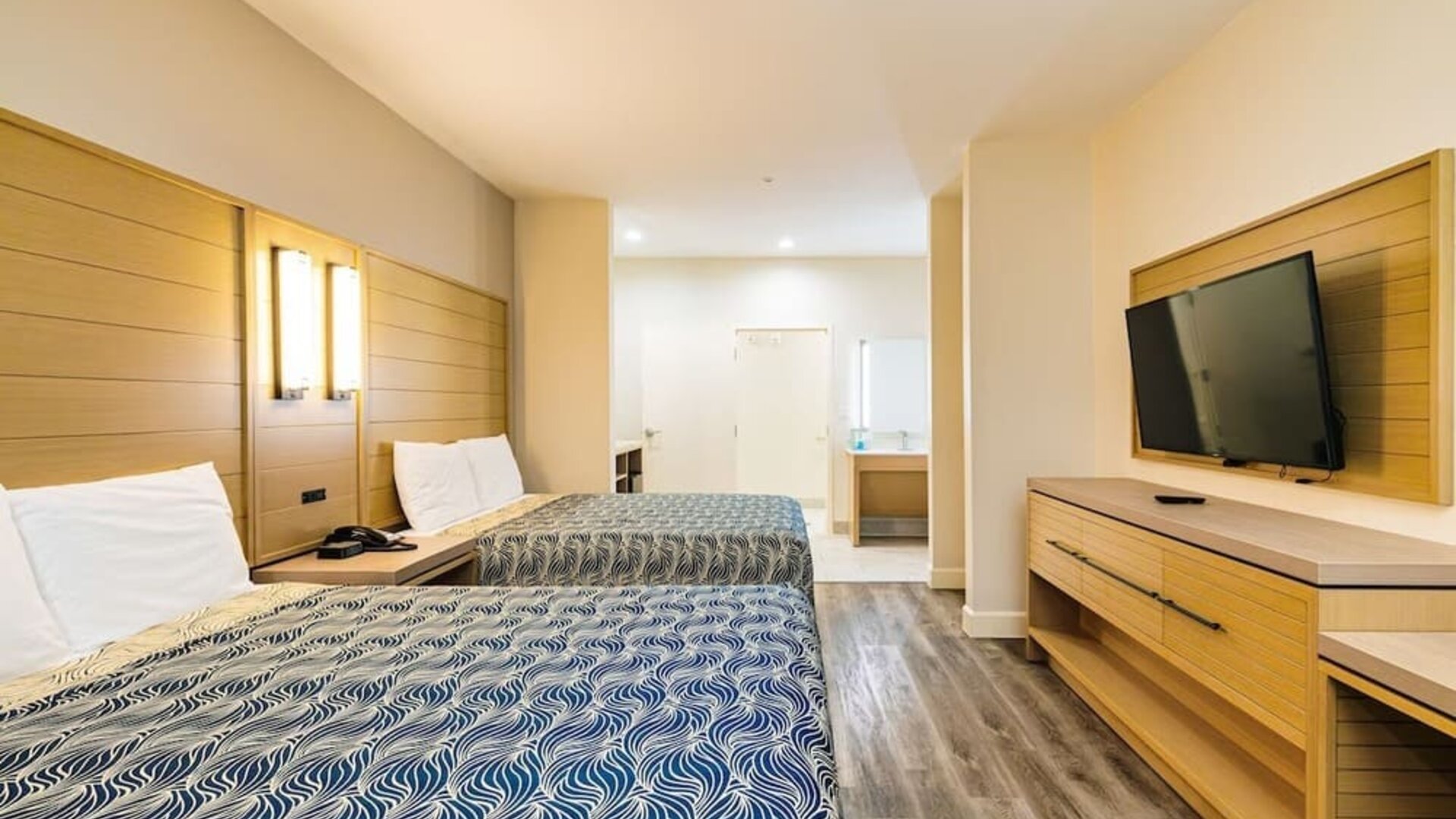 Day use twin room with private bathroom and workspace at Palace Inn Blue IAH East.