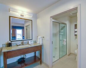 Private guest bathroom with shower and free toiletries at Hampton Inn & Suites Trophy Club - Fort Worth North, TX.