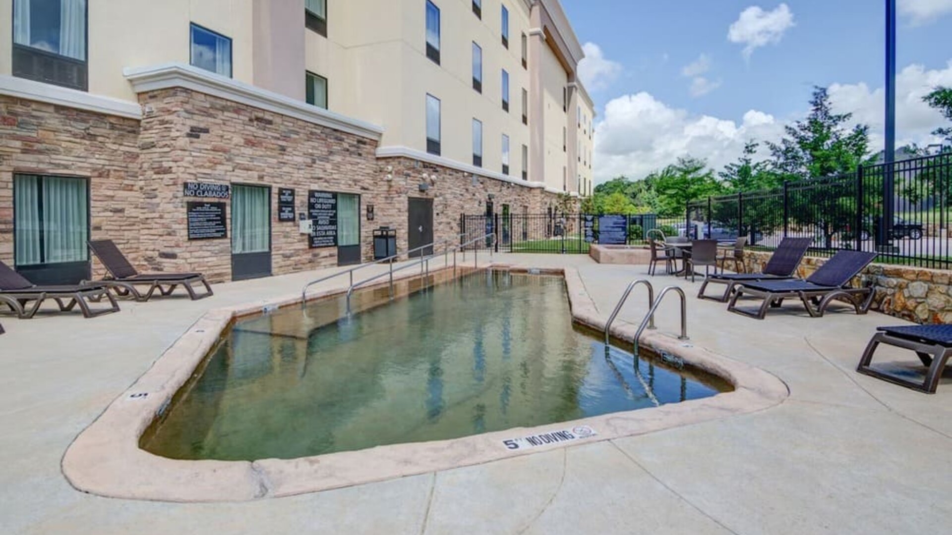 Outdoor pool with lounge chairs at Hampton Inn & Suites Trophy Club - Fort Worth North, TX.