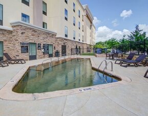 Outdoor pool with lounge chairs at Hampton Inn & Suites Trophy Club - Fort Worth North, TX.