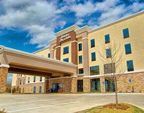 Hotel entrance and parking area at Hampton Inn & Suites Trophy Club - Fort Worth North, TX.