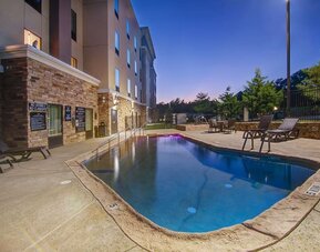Outdoor pool with lounge chairs at Hampton Inn & Suites Trophy Club - Fort Worth North, TX.