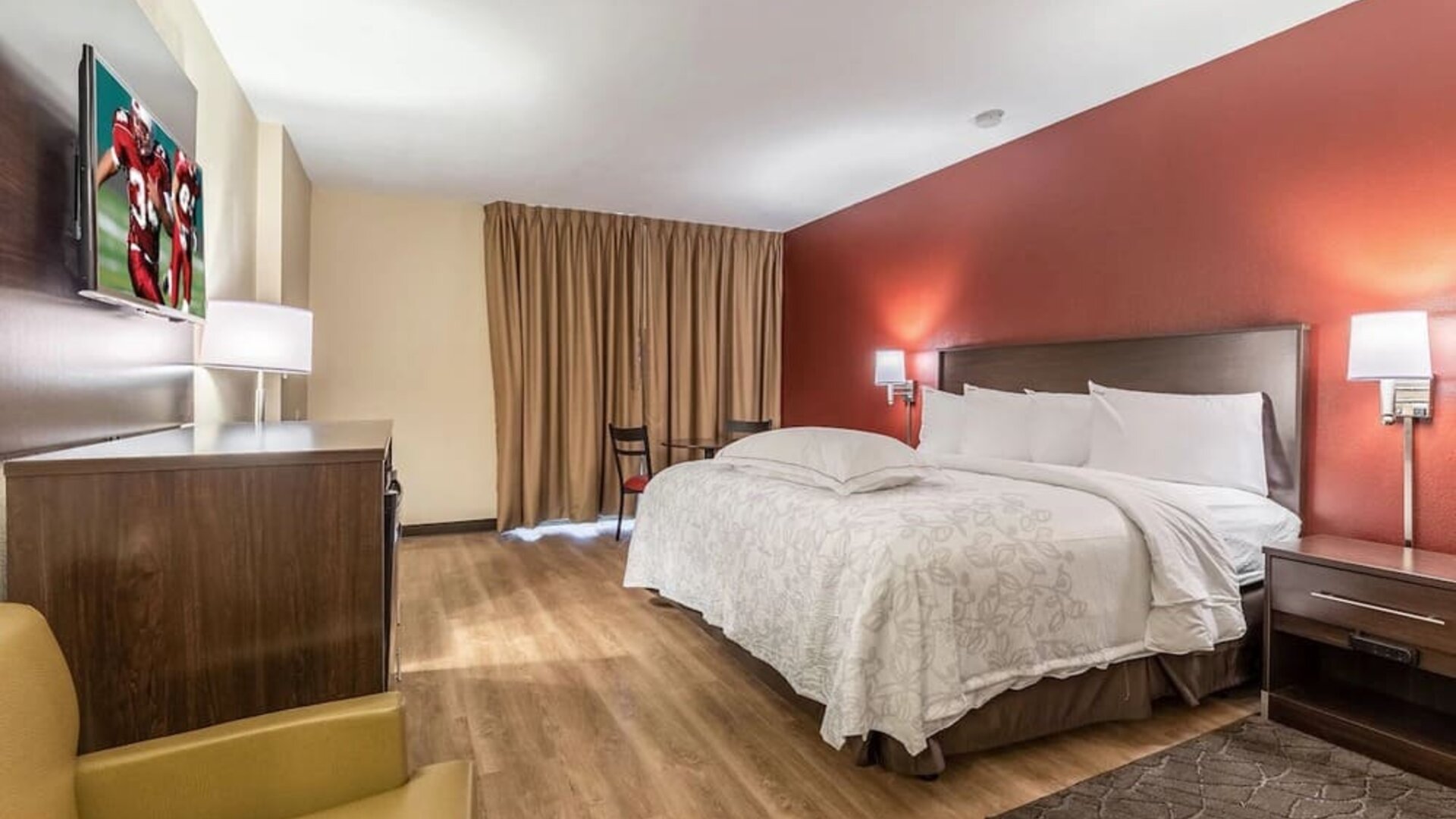 Day use room with king bed and workspace at Red Roof PLUS+ & Suites Houston - IAH Airport SW.