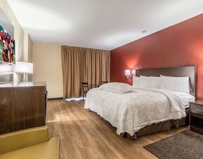 Day use room with king bed and workspace at Red Roof PLUS+ & Suites Houston - IAH Airport SW.