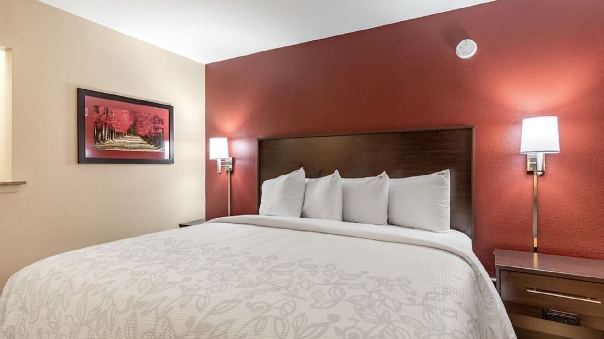 King bed at Red Roof PLUS+ & Suites Houston - IAH Airport SW.