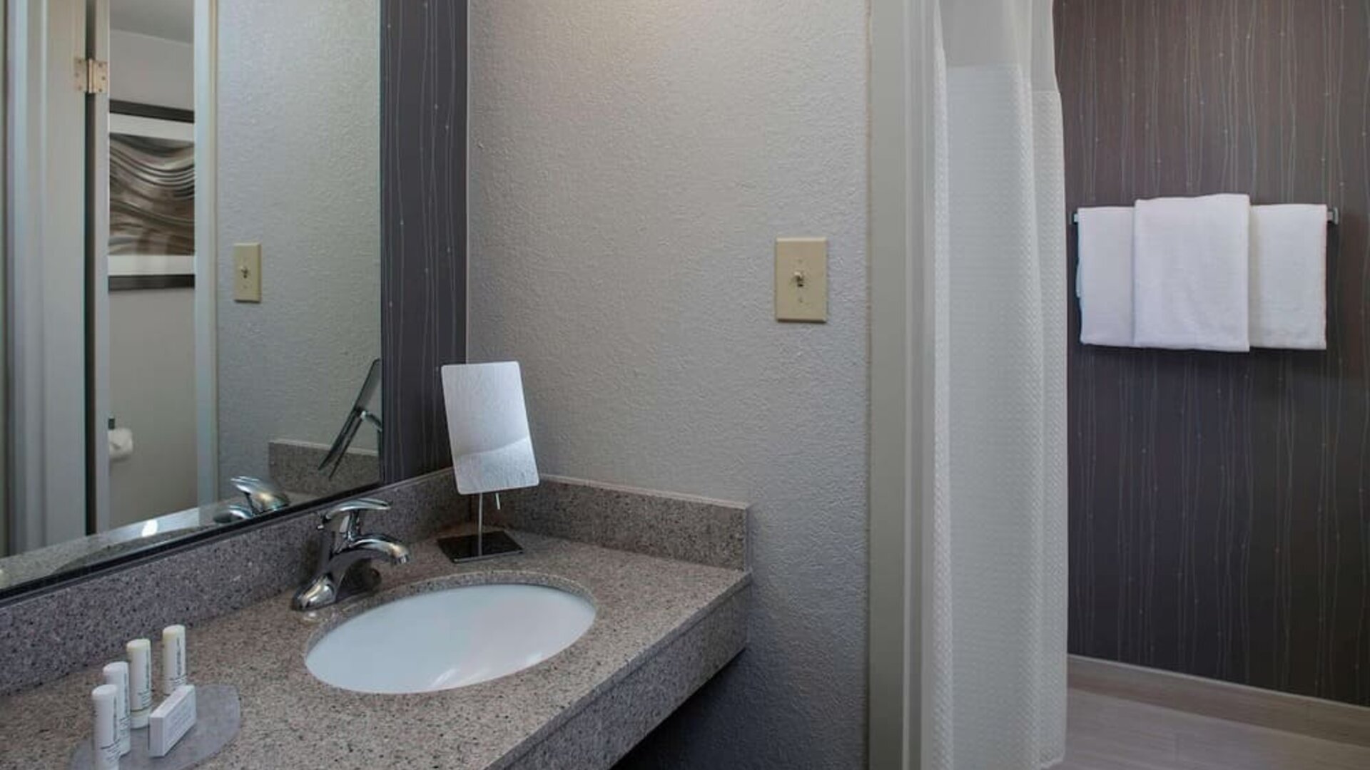 Private guest bathroom with shower and free toiletries at Sonesta Select Atlanta Norcross I-85.