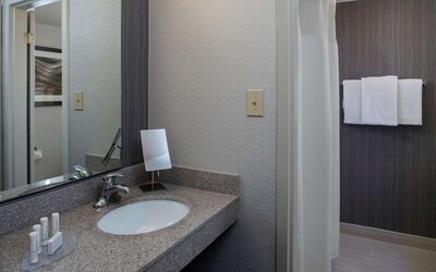 Private guest bathroom with shower and free toiletries at Sonesta Select Atlanta Norcross I-85.