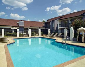 Outdoor pool with lounge chairs at Sonesta Select Atlanta Norcross I-85.