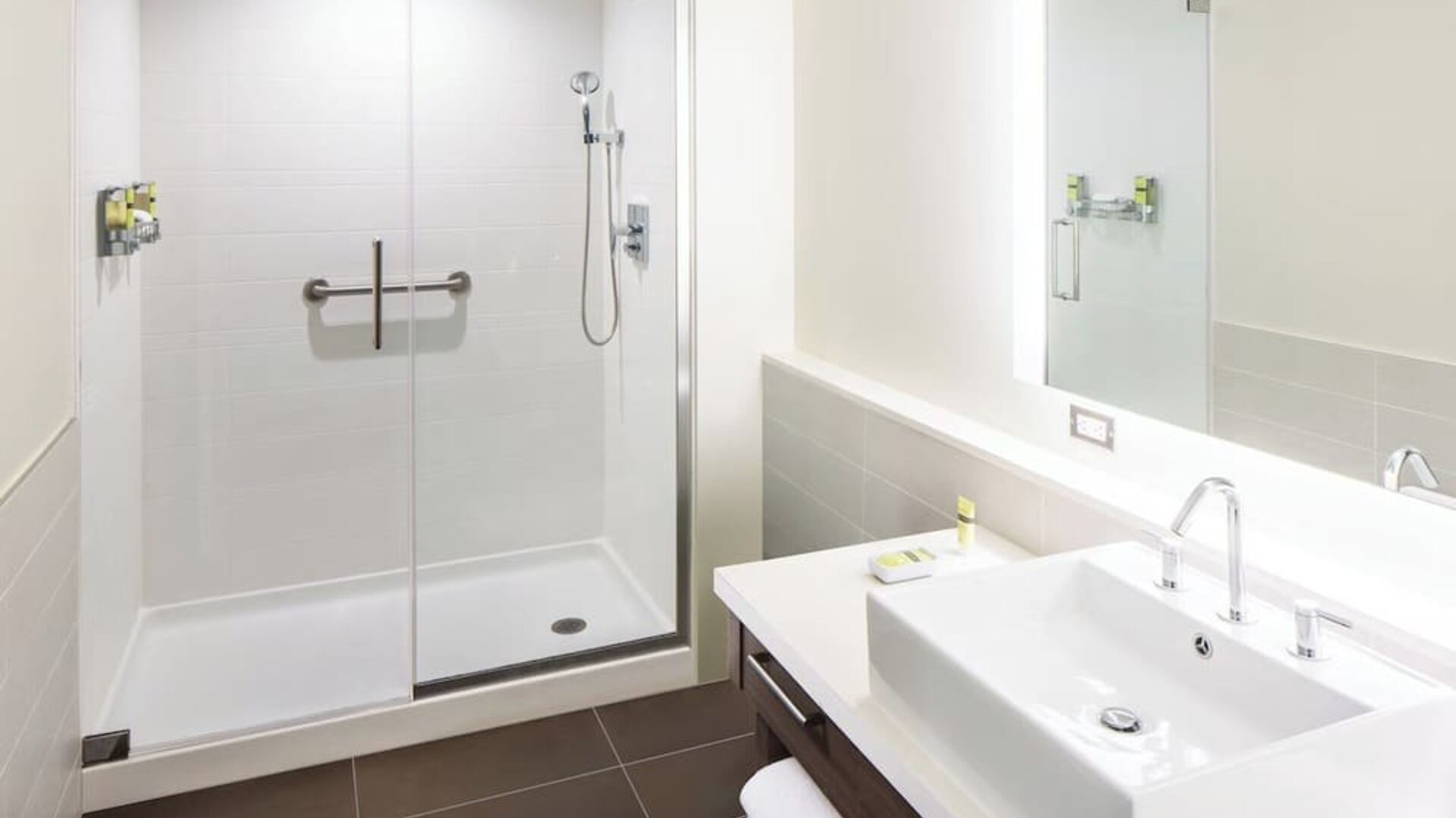 Private guest bathroom with shower and free toiletries at Element Miami International Airport.