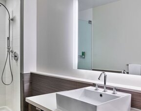 Private guest bathroom with shower at Element Miami International Airport.