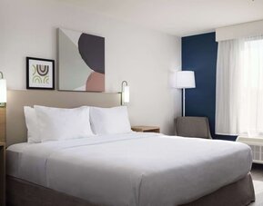 Day use room with king bed and tv at Spark By Hilton Guelph.