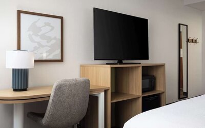 Day use room with king bed and tv at Spark By Hilton Guelph.