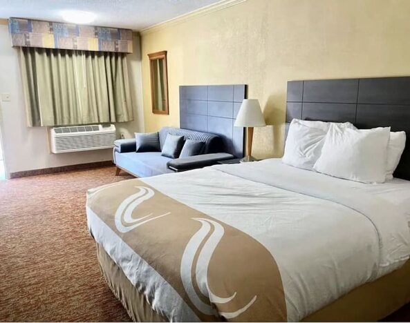 King bed with AC at Hibiscus Inn & Suites.