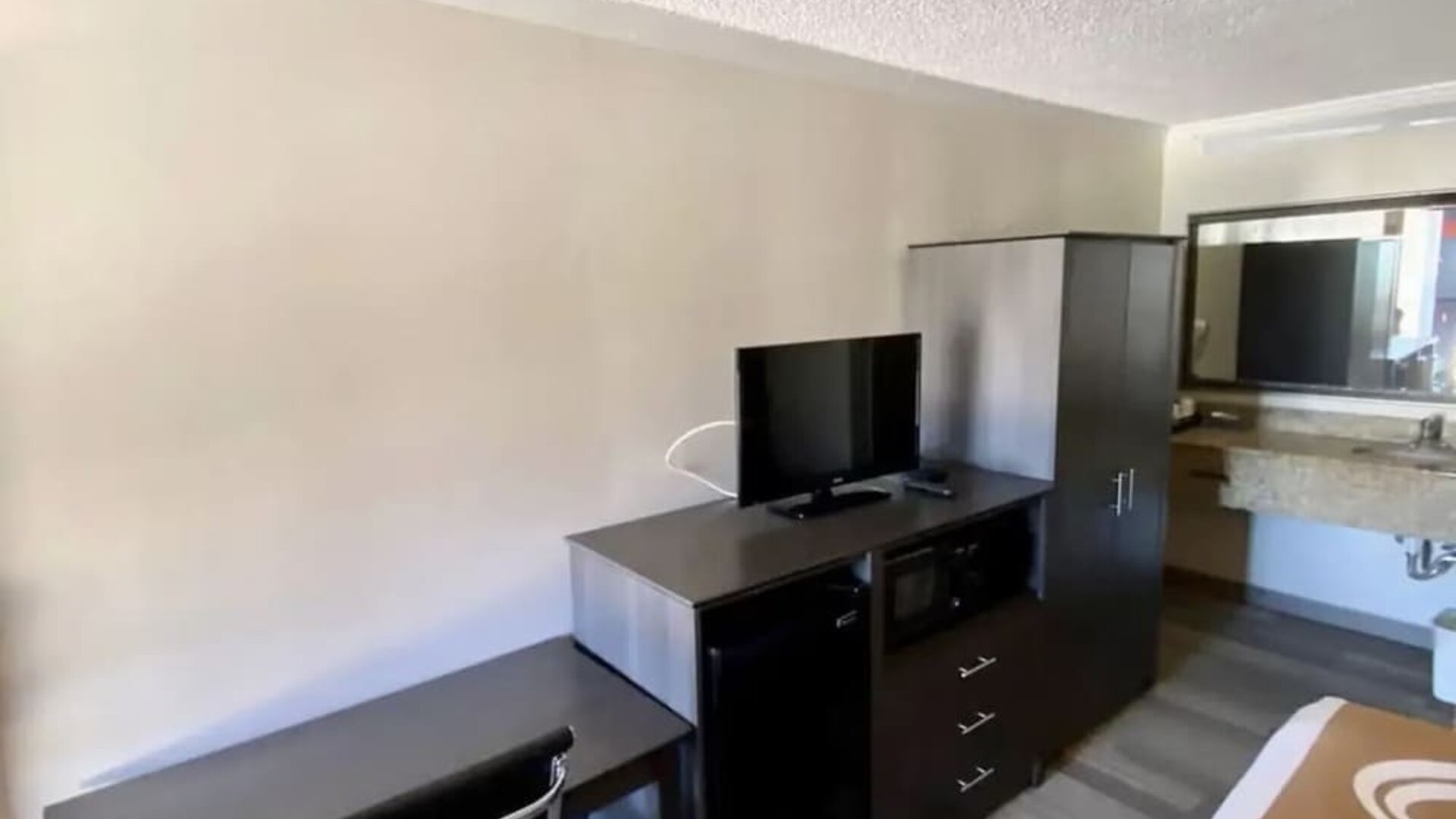 Desk and TV at Hibiscus Inn & Suites.