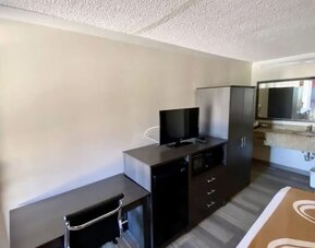 Desk and TV at Hibiscus Inn & Suites.