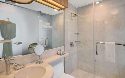 Private guest bathroom with shower and free toiletries at Wyndham Garden Brooklyn Sunset Park.