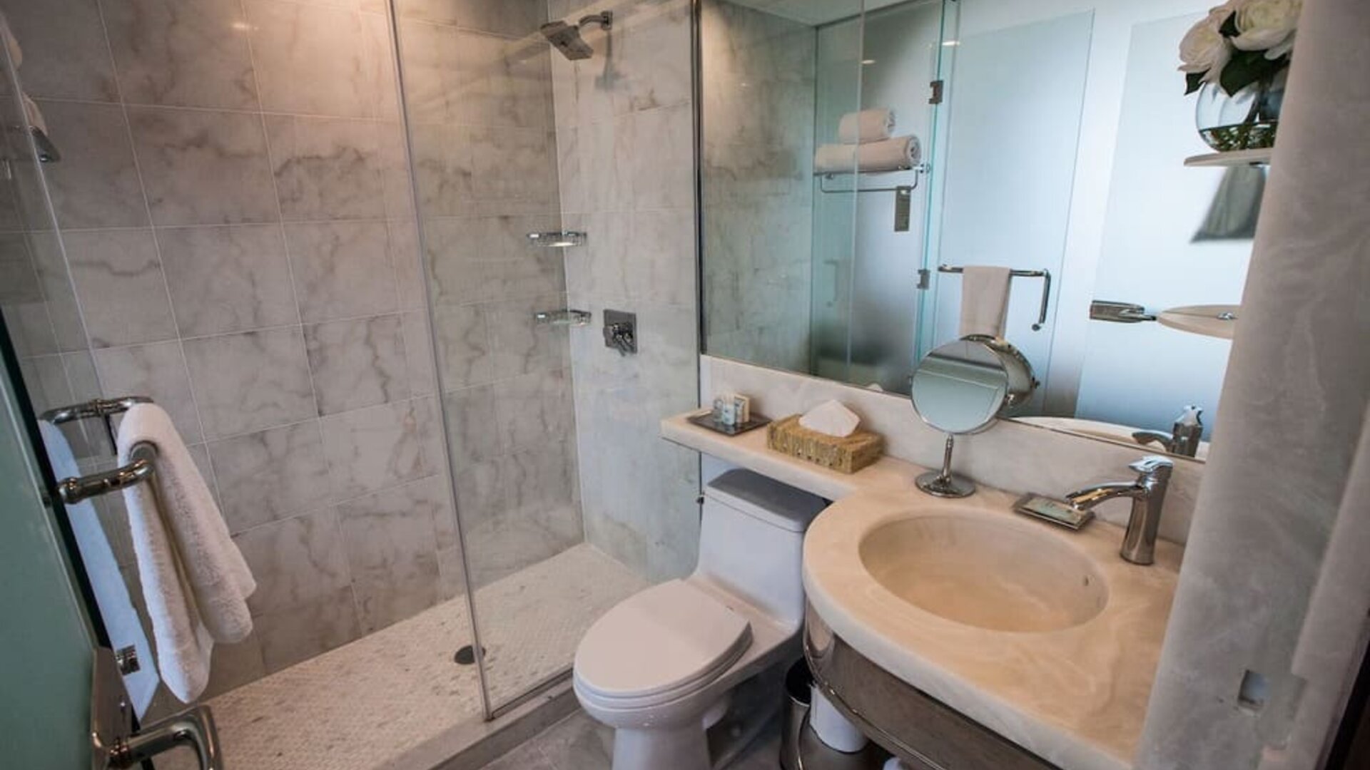 Private guest bathroom with shower and free toiletries at Wyndham Garden Brooklyn Sunset Park.