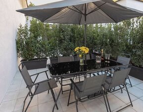 Outdoor terrace at Aiello Hotels - CityLife Apartments.