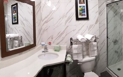 Private guest bathroom with shower and free toiletries at Days Inn By Wyndham Brooklyn Marine Park.