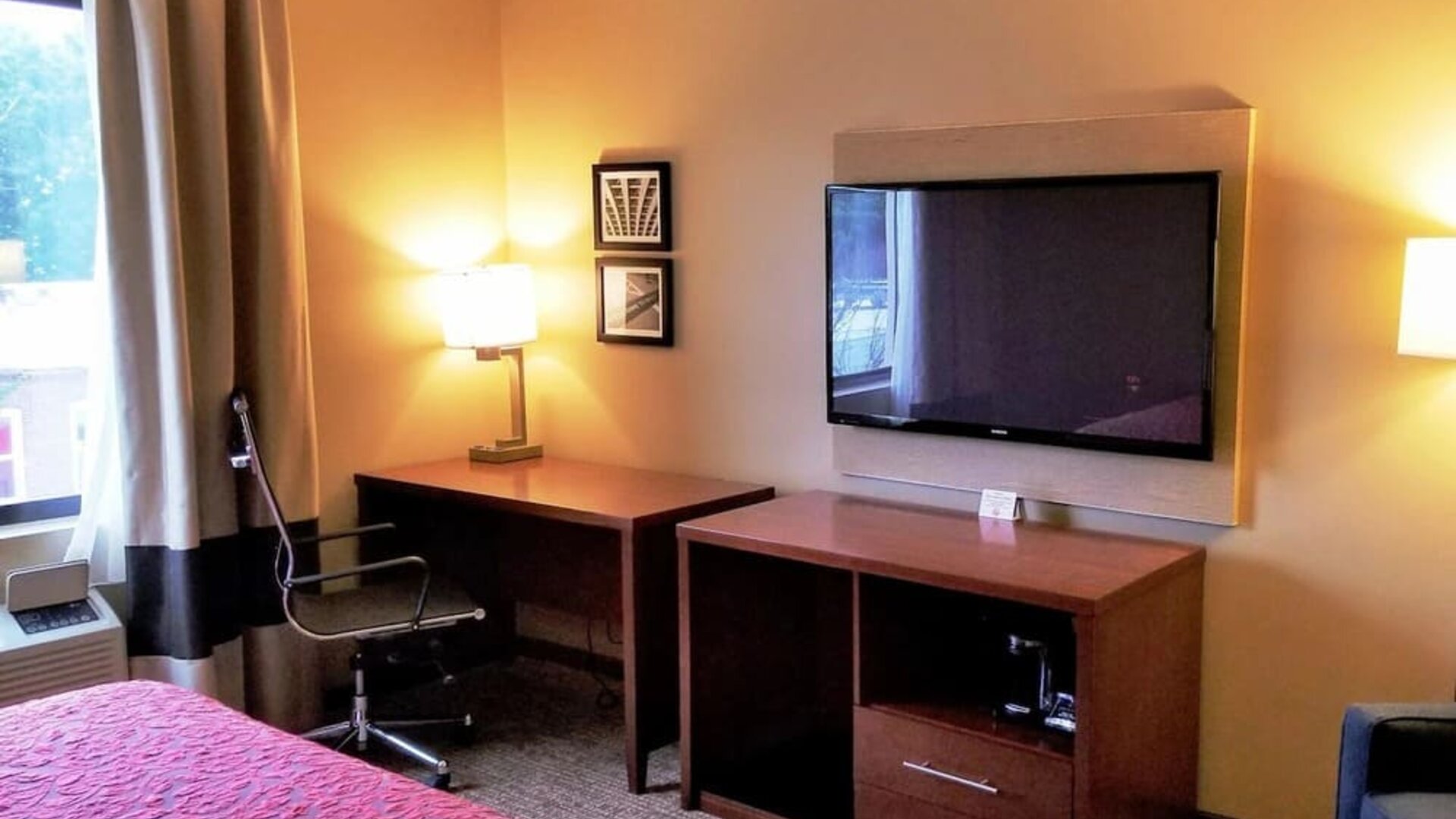 Day use room' workspace with TV screen, work desk and ergonomic chair at Days Inn By Wyndham Brooklyn Marine Park.