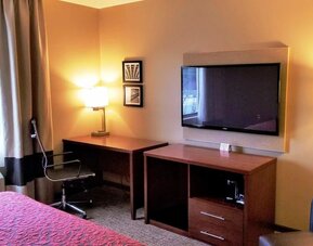Day use room' workspace with TV screen, work desk and ergonomic chair at Days Inn By Wyndham Brooklyn Marine Park.