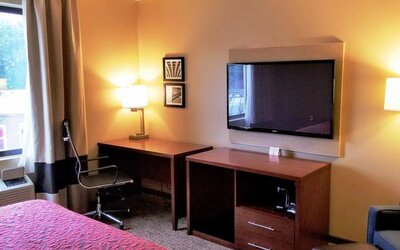 Day use room' workspace with TV screen, work desk and ergonomic chair at Days Inn By Wyndham Brooklyn Marine Park.