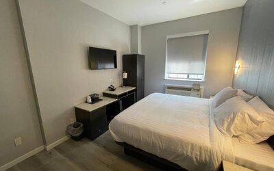 Standard room with king bed and workspace at King Hotel Brooklyn.