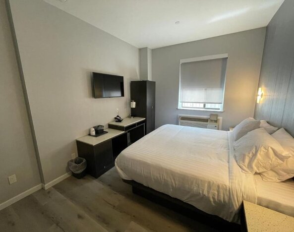 Standard room with king bed and workspace at King Hotel Brooklyn.