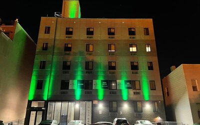 Exterior of King Hotel Brooklyn and parking area,