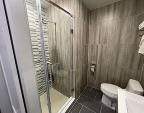 Private bathroom with shower at King Hotel Brooklyn.