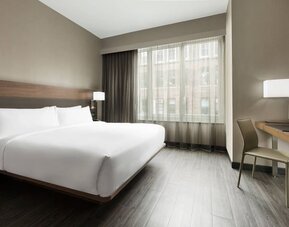 Standard day use room with king bed, large windows, work desk and private bathroom at AC Hotel New York Times Square.