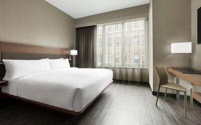 Standard day use room with king bed, large windows, work desk and private bathroom at AC Hotel New York Times Square.