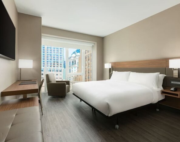Day use room with workspace, large windows and private bathroom at AC Hotel New York Times Square.