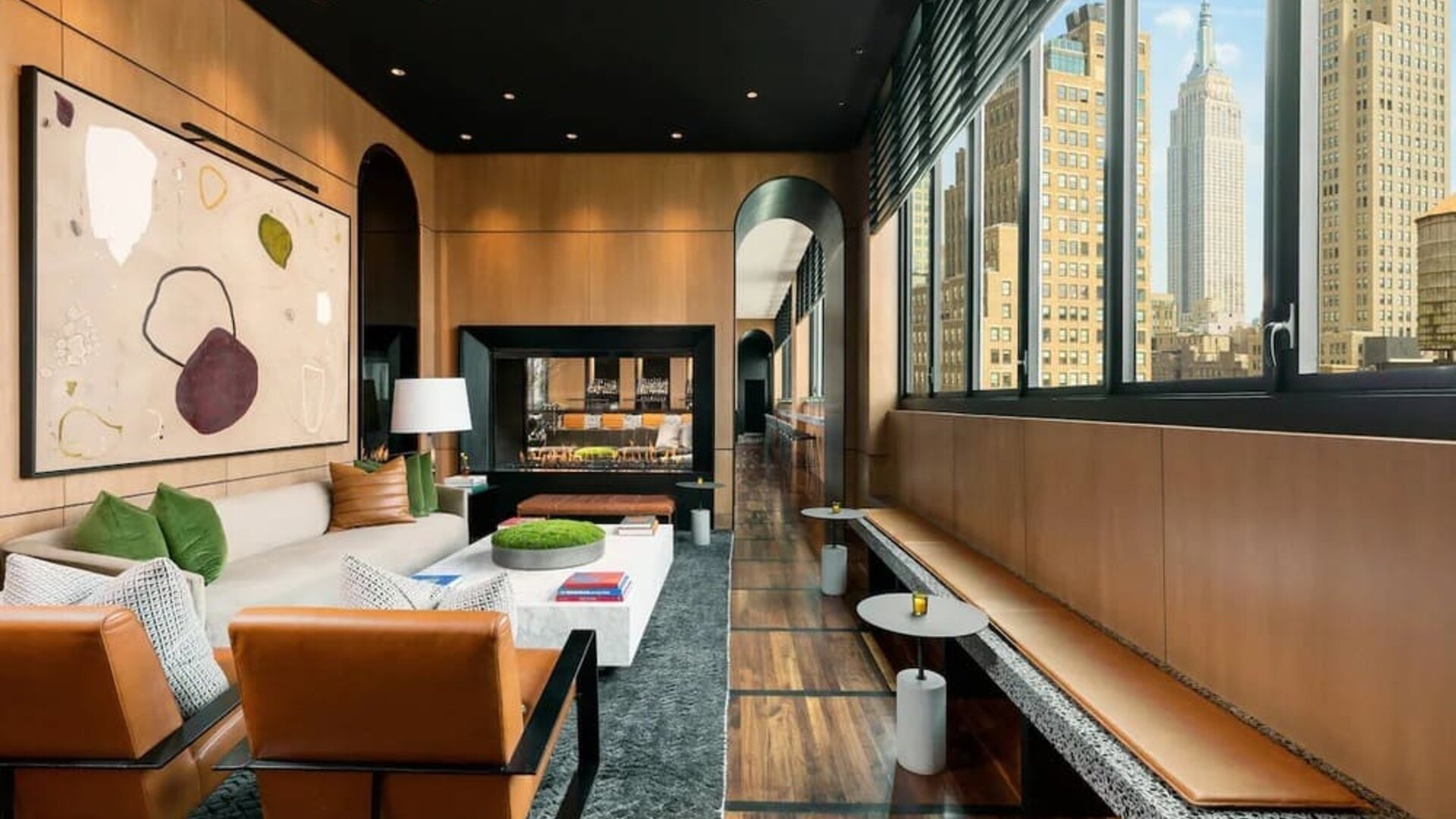 Lounge seating and workspace with fireplace at AC Hotel New York Times Square.