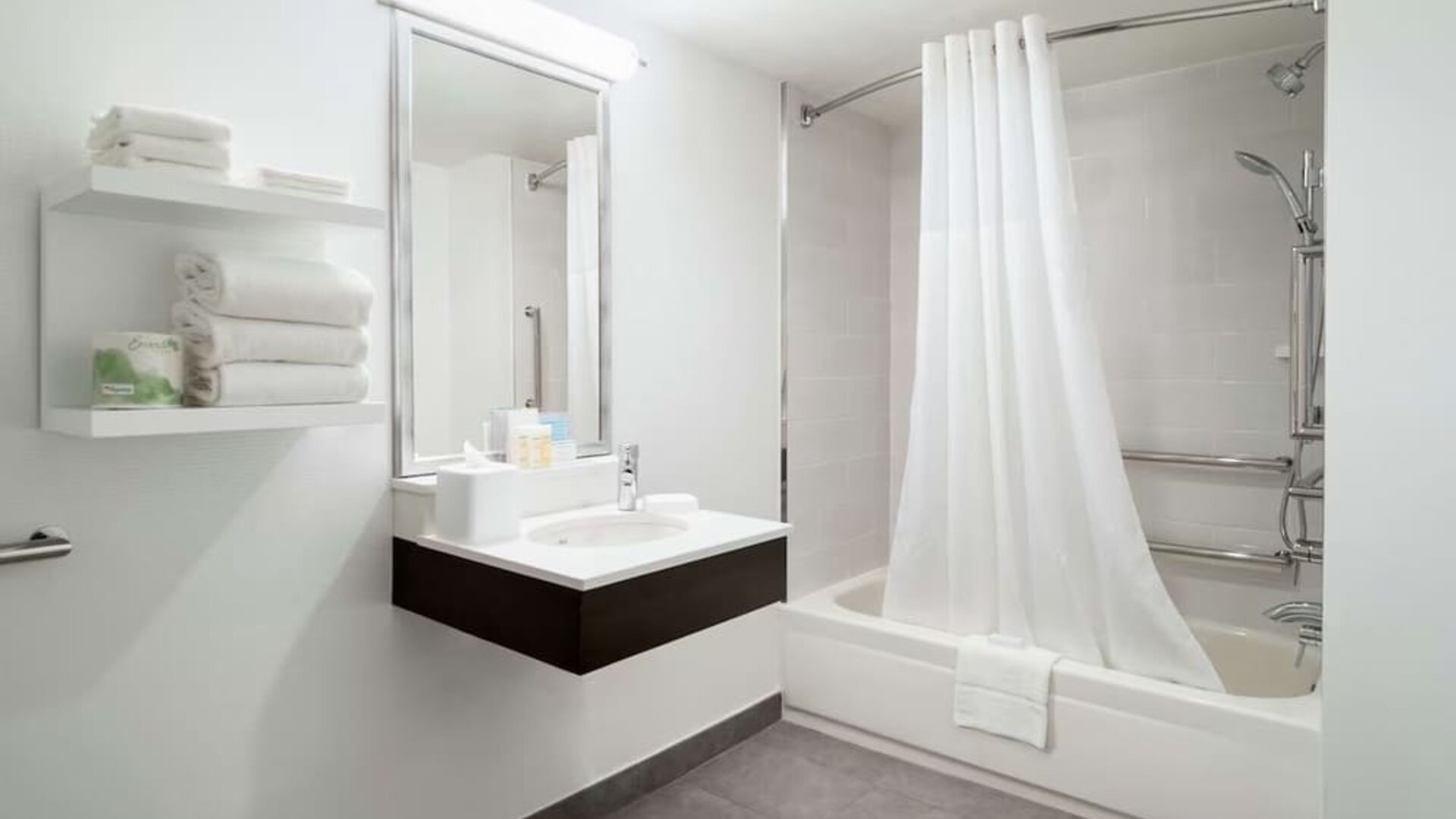 Private guest bathroom with combine shower and tub at Hampton Inn Manhattan Chelsea.