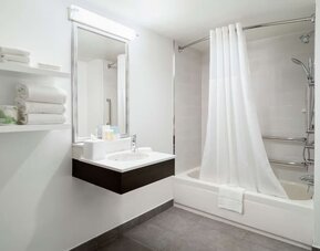 Private guest bathroom with combine shower and tub at Hampton Inn Manhattan Chelsea.