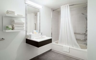 Private guest bathroom with combine shower and tub at Hampton Inn Manhattan Chelsea.