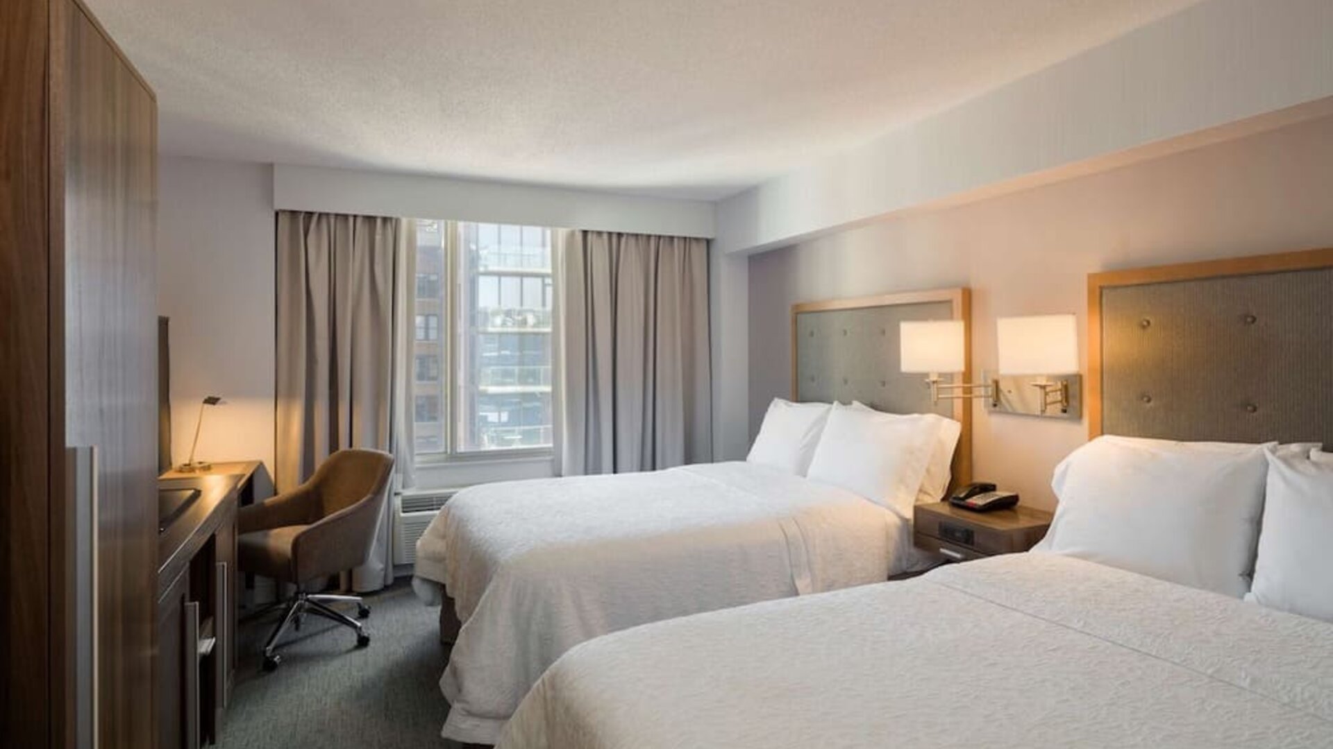 Day use twin room with work desk, large windows and private bathroom at Hampton Inn Manhattan Chelsea.