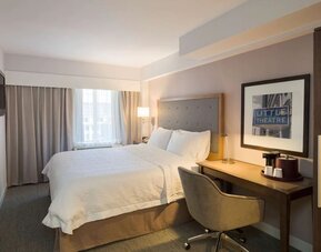 Day use room with king bed, work desk, natural light and private bathroom at Hampton Inn Manhattan - Madison Square Garden.
