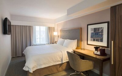 Day use room with king bed, work desk, natural light and private bathroom at Hampton Inn Manhattan - Madison Square Garden.
