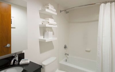 Private guest bathroom with combined shower and tub at Hampton Inn Manhattan - Madison Square Garden.