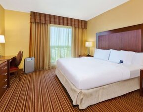 Day use room with work desk and natural light at Embassy Suites By Hilton Charlotte-Concord-Golf Resort & Spa.