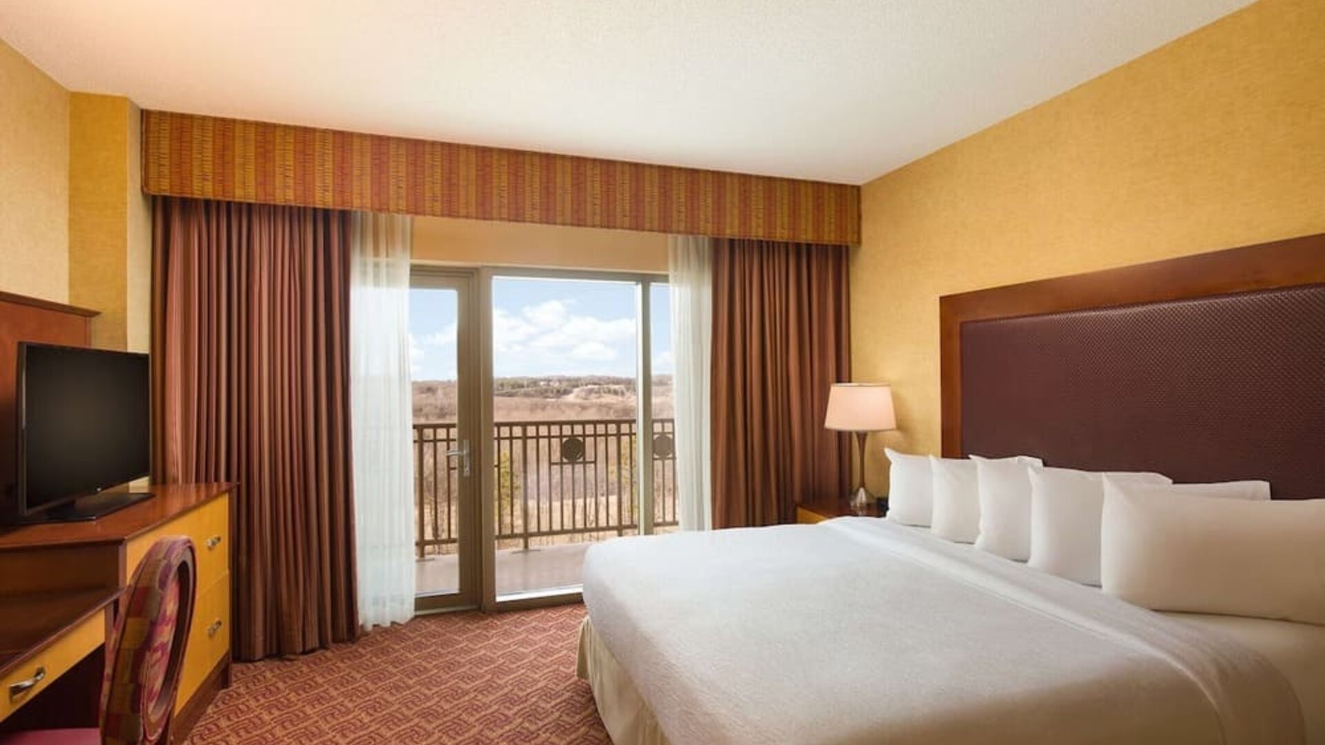 Day use room with balcony and work desk at Embassy Suites By Hilton Charlotte-Concord-Golf Resort & Spa.