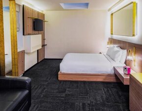 King room with workspace, lounge seating and private bathroom at Hotel Shocard NYC.