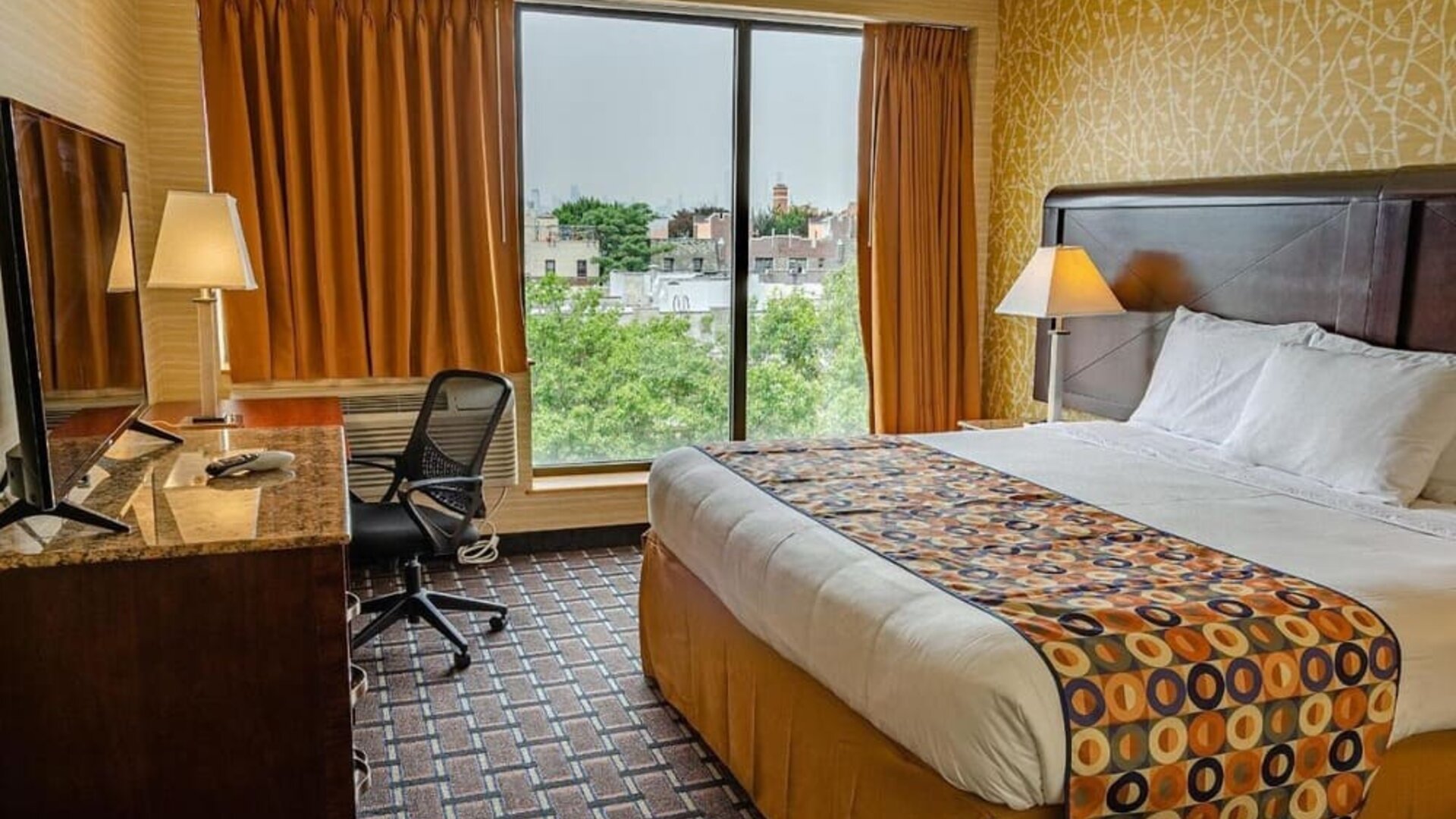 Day use room with king bed, work desk, large windows and private bathroom at Elmhurst Hotel.