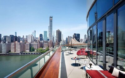 Rooftop terrace with comfortable seating and city view at Graduate New York.