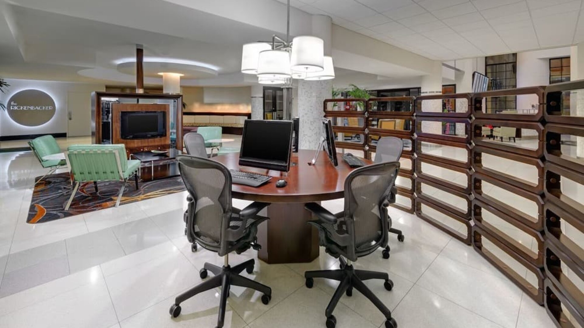 Business center with computers, printer and ergonomic chairs at Sheraton Miami Airport Hotel.