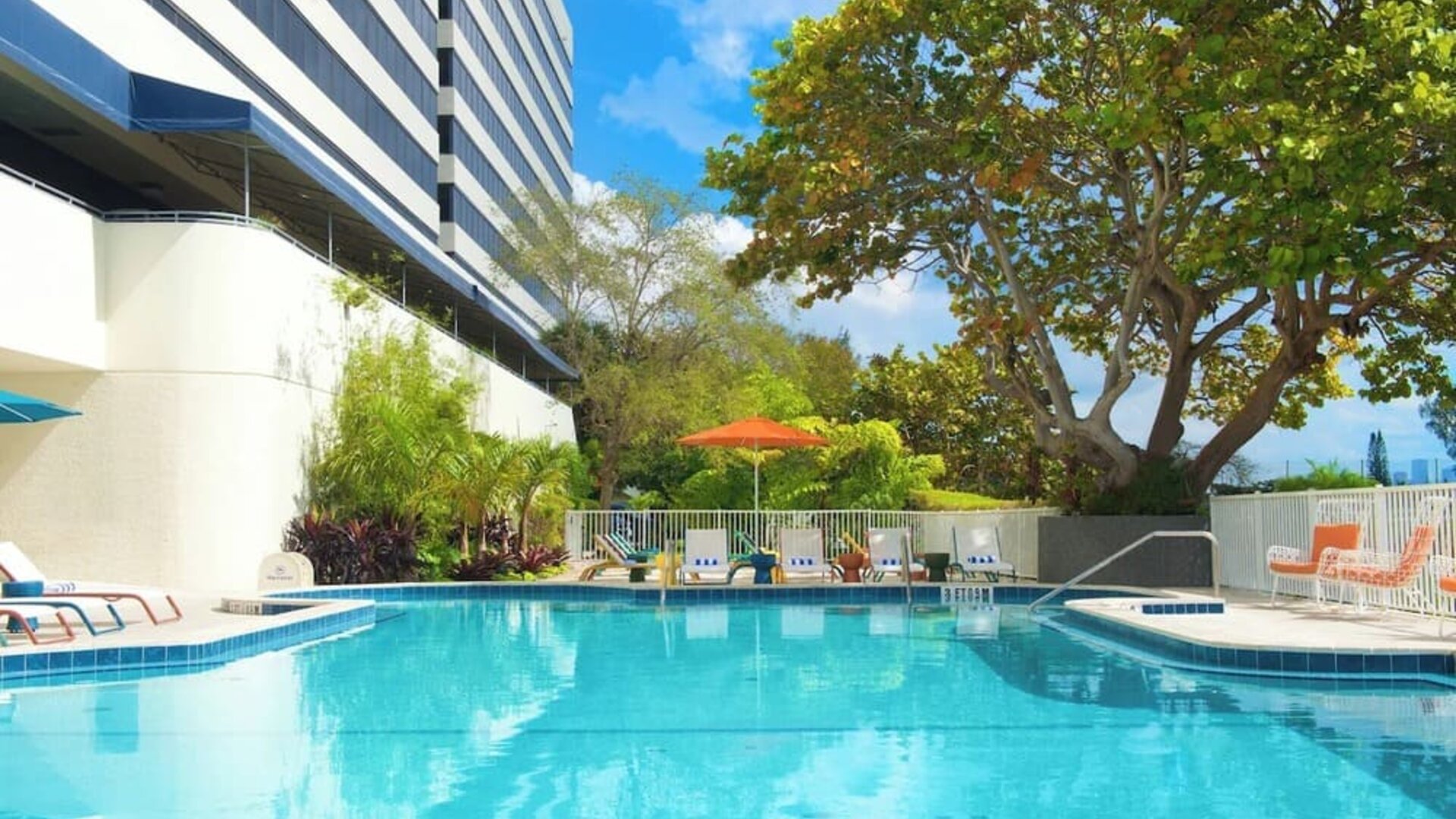 Outdoor pool with lounge chairs at Sheraton Miami Airport Hotel.