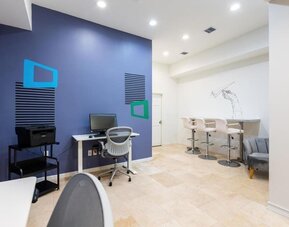Business center with computers, printer and ergonomic chairs at Regency Miami Airport By Sonesta.