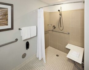Private guest bathroom with accesible shower and free toiletries at Courtyard Miami Dolphin Mall.